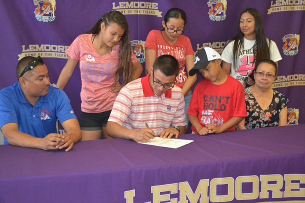 Chance Solis signs letter of intent to wrestle at Fresno State while father Angel Solis looks on. Other family members include Nyomi Solis, Aaden Solis, Celeste Ramirez, Vanessa Maldonado and grandmother, Eluid Maldonaldo.